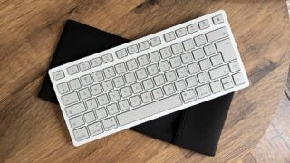 The Cherry KW 7100 Mini BT sitting on its travel pouch.